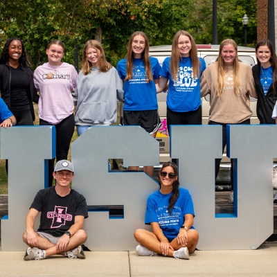 Students posing in front of ISU letters