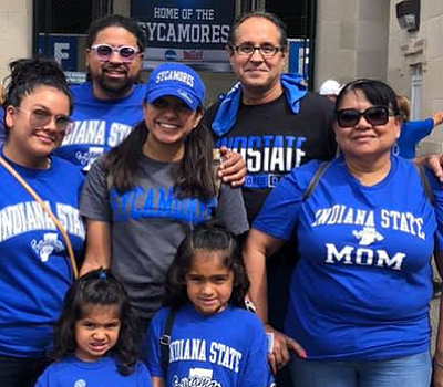 Family wearing ISU blue shirts outside