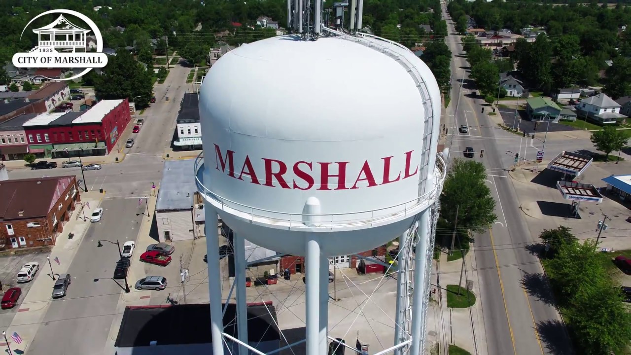 Overhead image of a water tower with the name Marshall on it in red coloring.