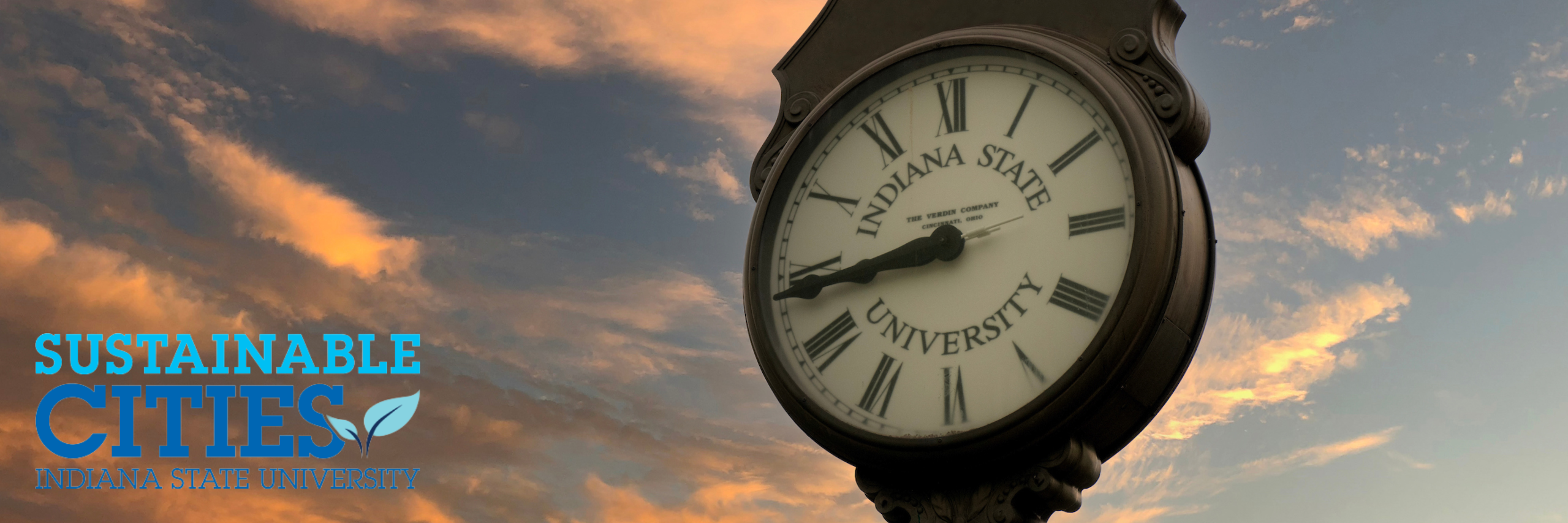 An image of the alumni clock and a cloudy sunset background with the Sustainable Cities logo in the bottom left corner