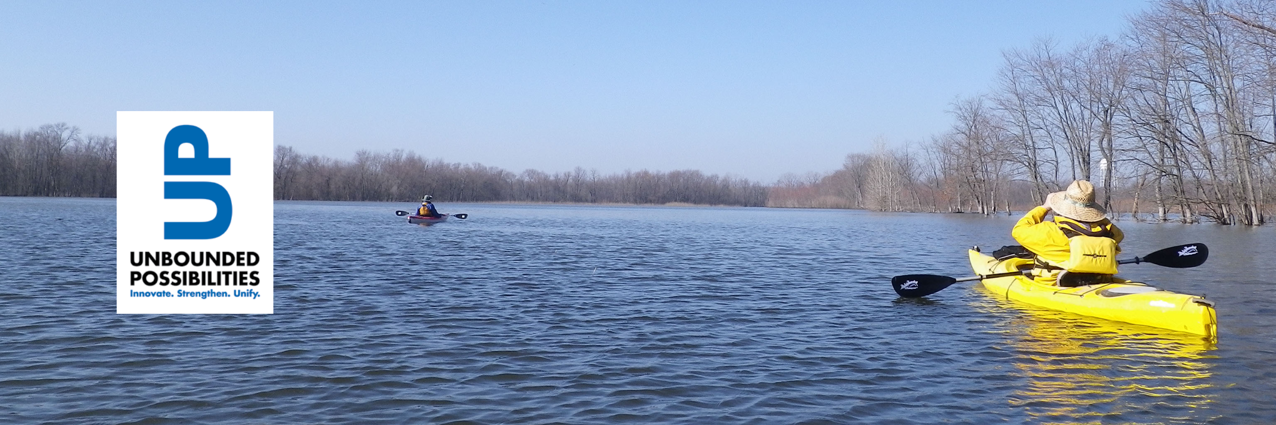An image of two people in a kayak in the Wabashikii with a logo for unbounded possibilities on teh left side of the image
